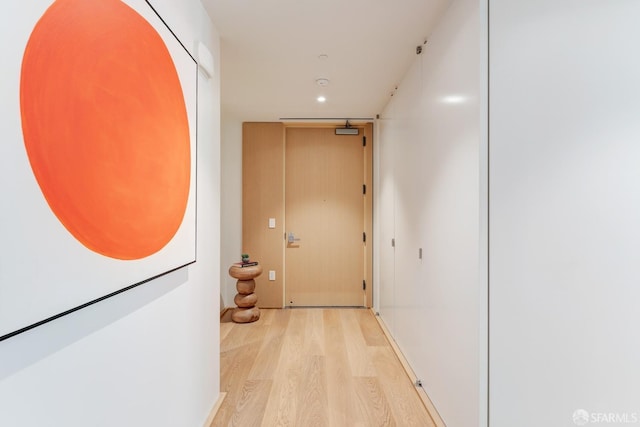 hallway with light hardwood / wood-style flooring