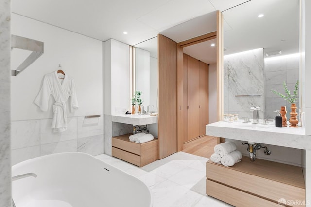 bathroom with vanity and a tub