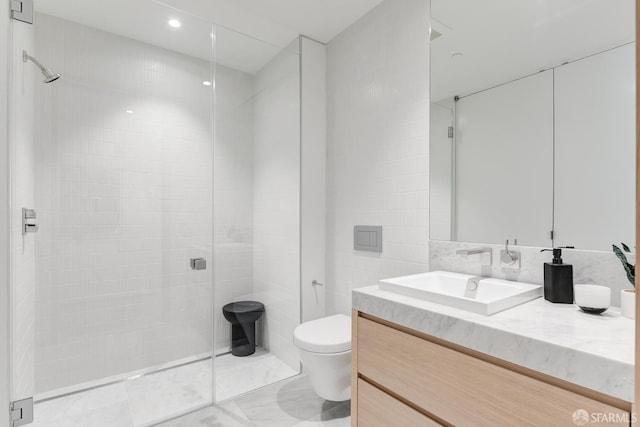 bathroom featuring vanity, tile walls, toilet, and tiled shower