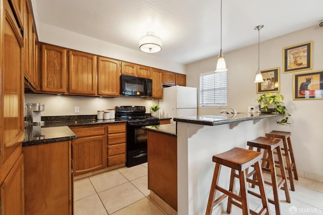 1421 El Camino Real Unit 3, Burlingame, CA 94010 - kitchen featuring black appliances, a breakfast bar, a peninsula, brown cabinetry, and light tile patterned floors