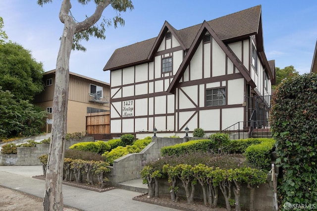 1421 El Camino Real Unit 3, Burlingame, CA 94010 - view of property exterior with stucco siding, roof with shingles, and stairs