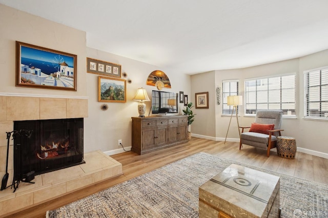 1421 El Camino Real Unit 3, Burlingame, CA 94010 - living room featuring light wood finished floors, baseboards, and a fireplace