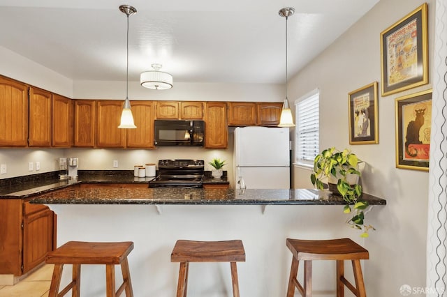 1421 El Camino Real Unit 3, Burlingame, CA 94010 - kitchen with black appliances, brown cabinetry, a peninsula, and a breakfast bar