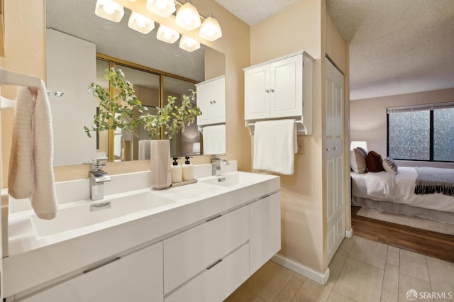 bathroom featuring a textured ceiling and vanity