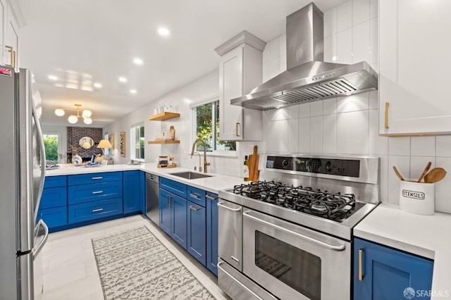 2811 Bayview Dr, Alameda, CA 94501 - kitchen featuring appliances with stainless steel finishes, wall chimney exhaust hood, a sink, blue cabinetry, and recessed lighting