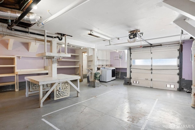 garage with a garage door opener and washer / dryer