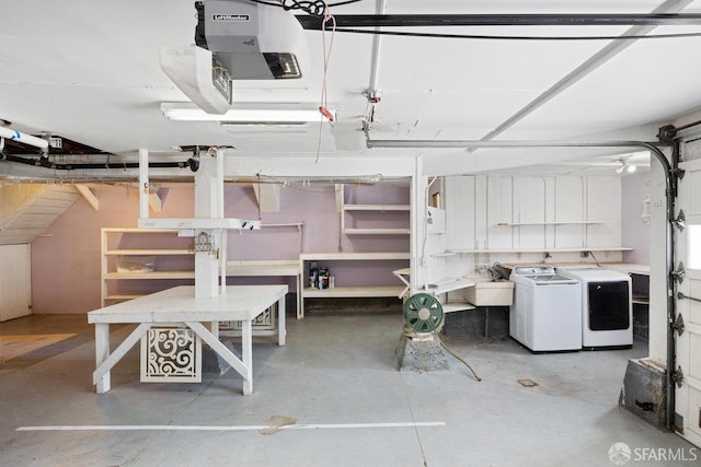 garage with separate washer and dryer and a garage door opener