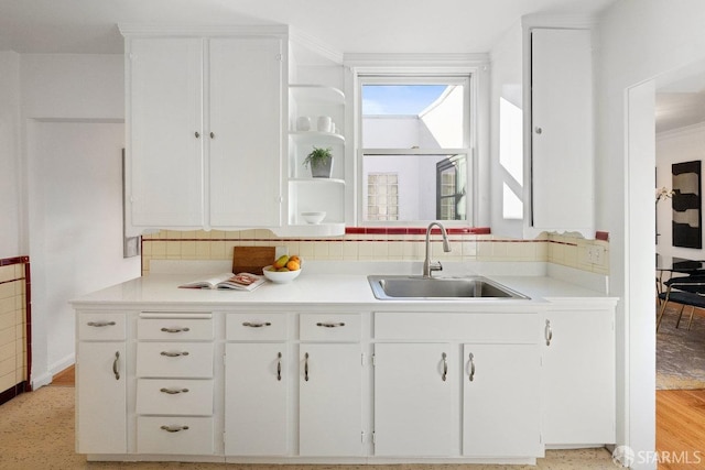 kitchen with white cabinetry and sink