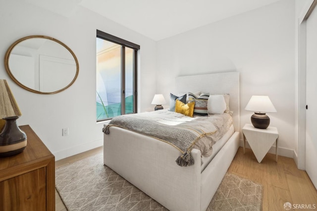 2177 3rd St Unit 321, San Francisco, CA 94107 - bedroom featuring wood finished floors, access to exterior, and baseboards