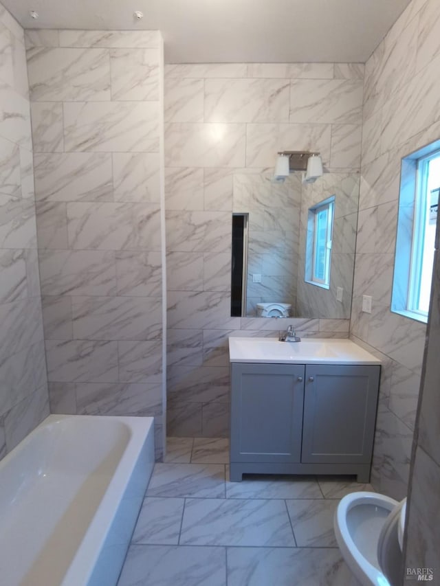 bathroom featuring vanity, plus walk in shower, and tile walls