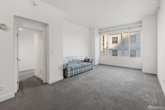 unfurnished room featuring dark carpet