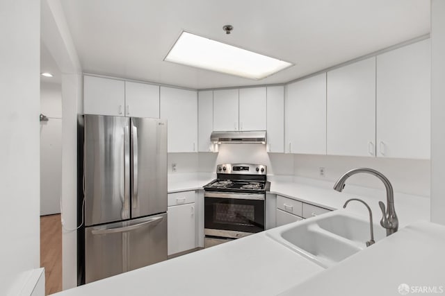 kitchen with light hardwood / wood-style floors, sink, white cabinetry, and stainless steel appliances