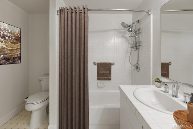 full bathroom featuring tile patterned flooring, tiled shower / bath combo, toilet, and vanity