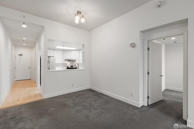 empty room with dark colored carpet