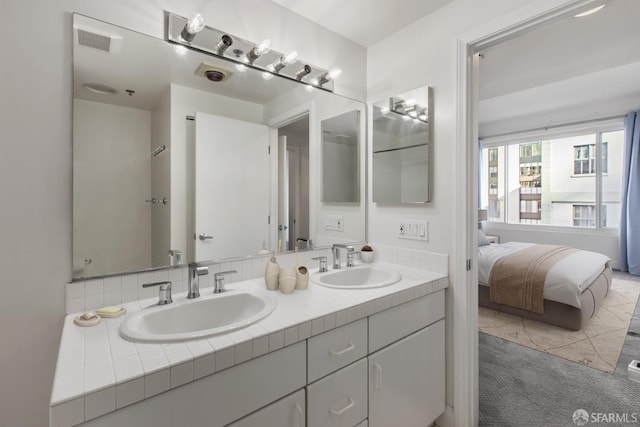 bathroom with tile patterned flooring and vanity