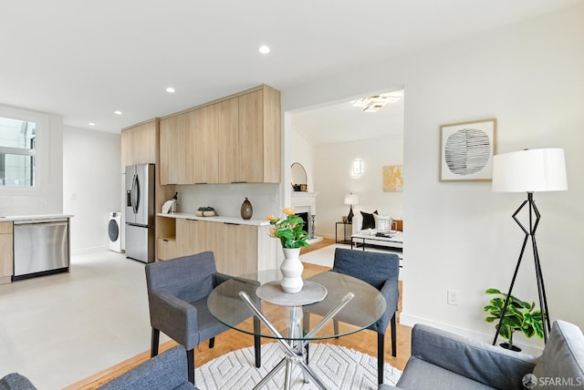 1204-1206 Funston Ave, San Francisco, CA 94122 - dining space featuring washer / clothes dryer, a fireplace with raised hearth, and recessed lighting