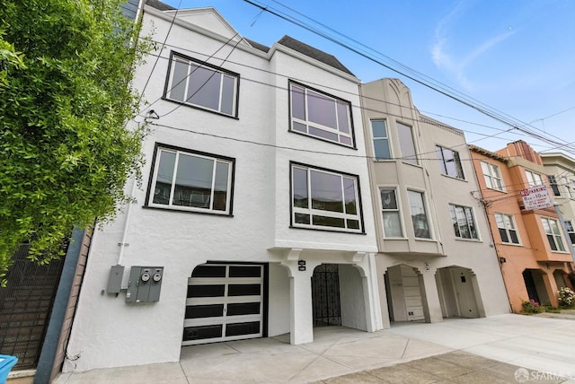 1204-1206 Funston Ave, San Francisco, CA 94122 - view of front facade featuring an attached garage, stucco siding, and concrete driveway