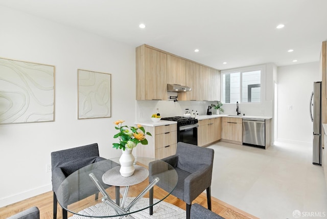 1204-1206 Funston Ave, San Francisco, CA 94122 - kitchen featuring light brown cabinets, appliances with stainless steel finishes, under cabinet range hood, light countertops, and modern cabinets