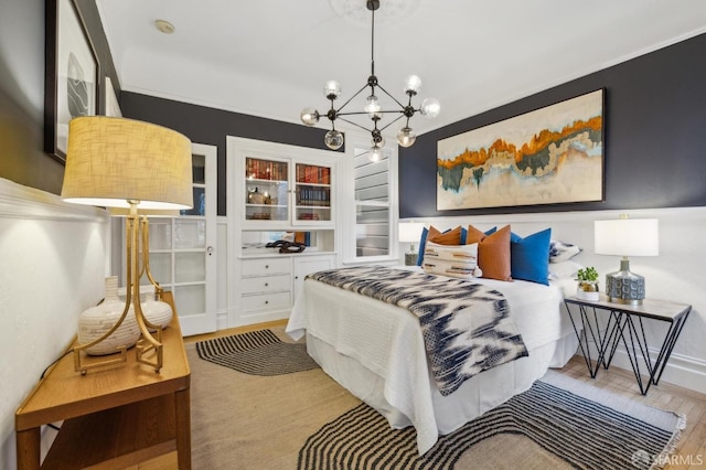 bedroom with wood-type flooring and an inviting chandelier