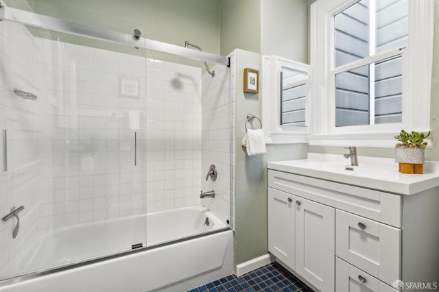 bathroom featuring tile patterned floors, combined bath / shower with glass door, and vanity