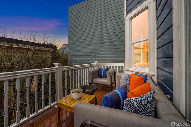 deck at dusk featuring outdoor lounge area