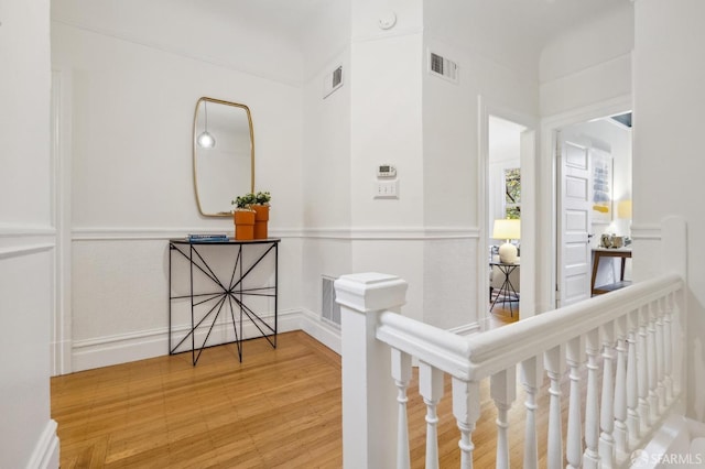 corridor with hardwood / wood-style floors