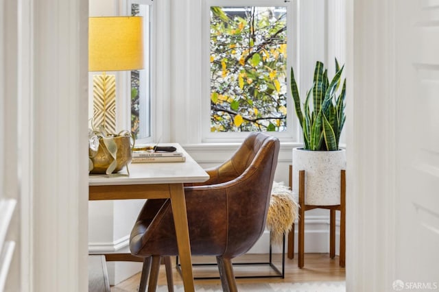 living area with plenty of natural light and light hardwood / wood-style floors