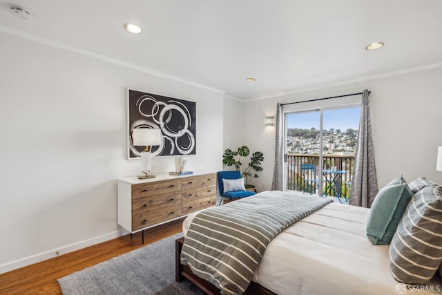 bedroom featuring baseboards, ornamental molding, wood finished floors, access to outside, and recessed lighting