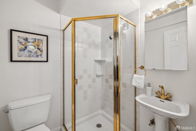 full bath with a stall shower, a sink, and toilet