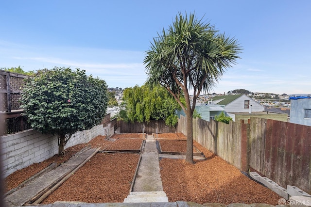 view of yard featuring a fenced backyard and a vegetable garden