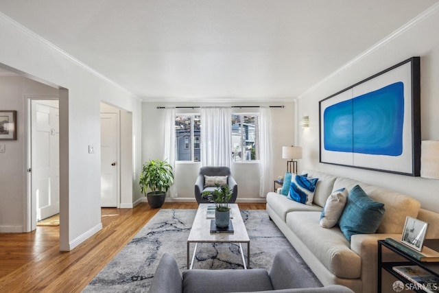 living room with light wood-type flooring and ornamental molding