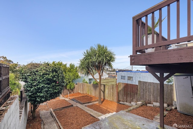 view of yard featuring fence and a vegetable garden