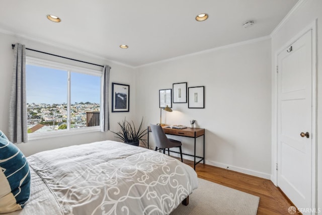 bedroom with baseboards, ornamental molding, wood finished floors, and recessed lighting