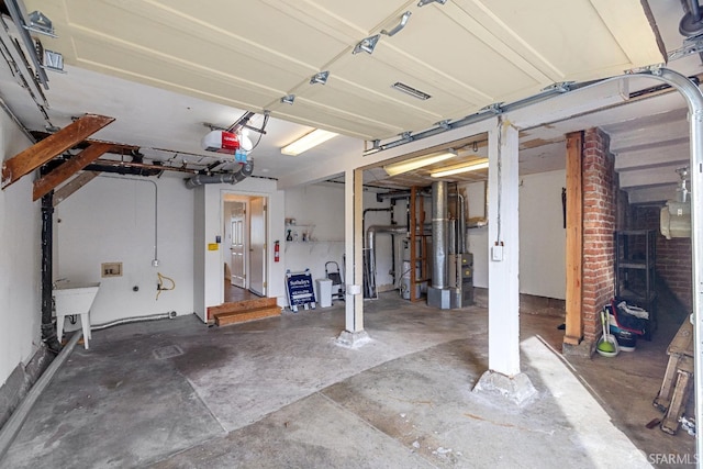 garage featuring a garage door opener, visible vents, and a sink