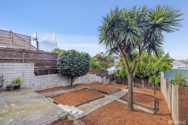 view of yard with a fenced backyard and a vegetable garden