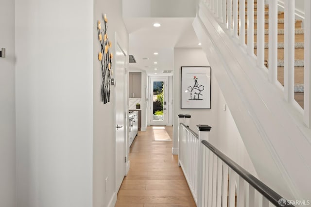 corridor with light hardwood / wood-style floors