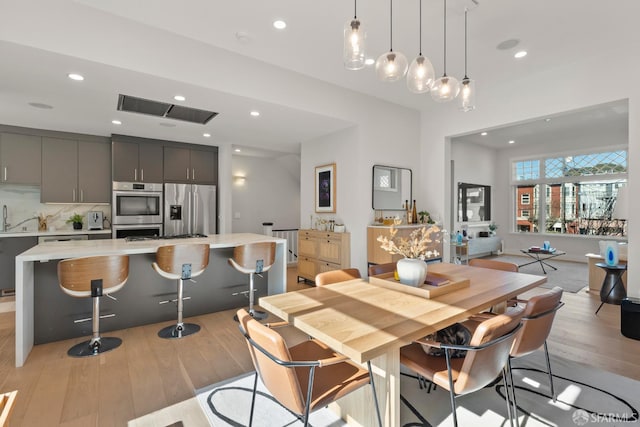 dining area featuring sink and light hardwood / wood-style floors