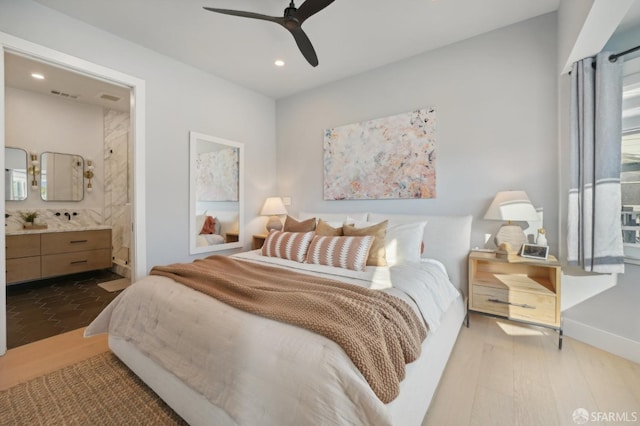 bedroom featuring hardwood / wood-style flooring, ensuite bath, and ceiling fan