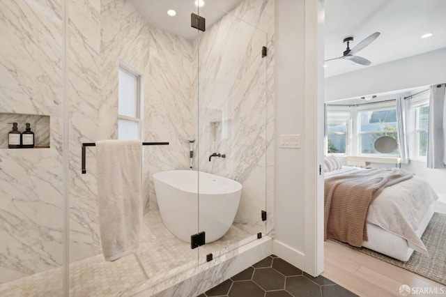 bathroom featuring separate shower and tub and ceiling fan