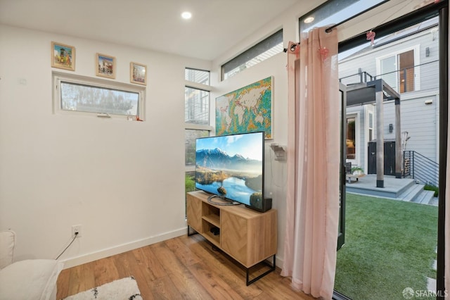 corridor with light hardwood / wood-style flooring