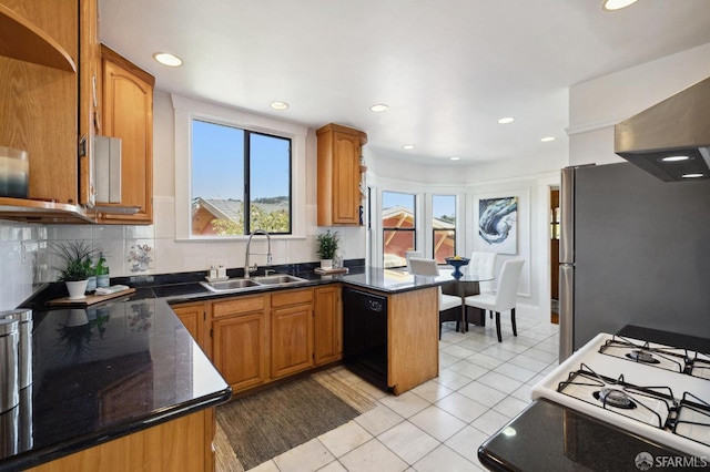 kitchen with sink, black dishwasher, kitchen peninsula, stainless steel fridge, and light tile patterned floors