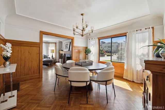 dining area featuring parquet floors and an inviting chandelier