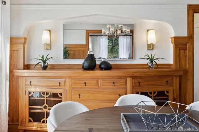 dining room with a chandelier and crown molding