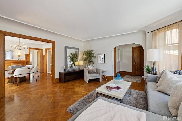 living room featuring parquet floors and a notable chandelier