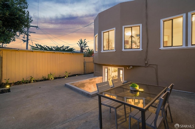 view of patio terrace at dusk