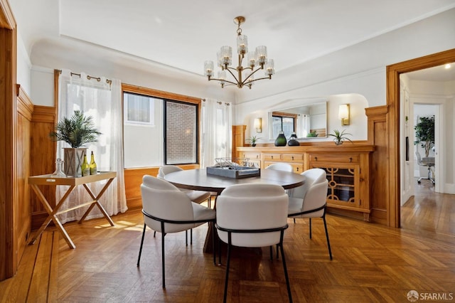 dining room with an inviting chandelier and parquet floors