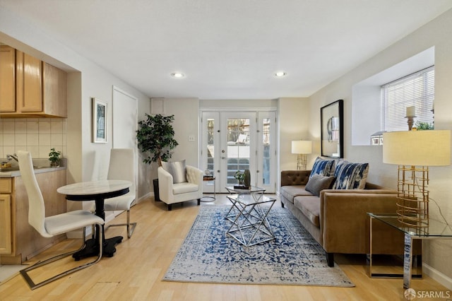 living room featuring french doors and light hardwood / wood-style floors