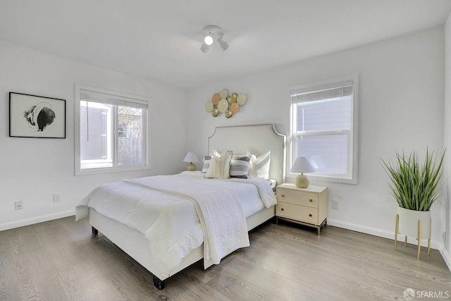 bedroom featuring baseboards and wood finished floors