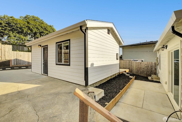 exterior space featuring an outbuilding and fence