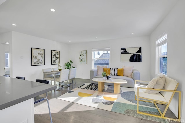 living room featuring recessed lighting, baseboards, and wood finished floors